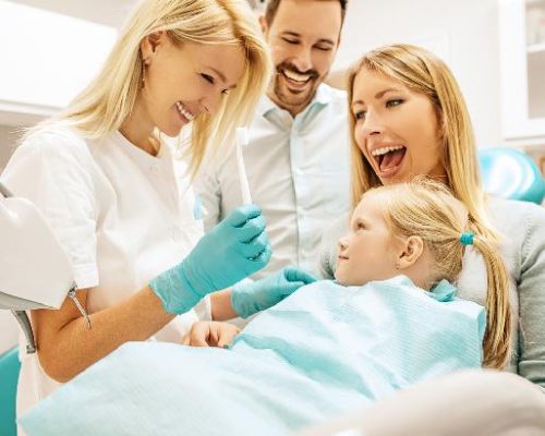 a mom helps her daughter during their routine dental checkups and cleanings